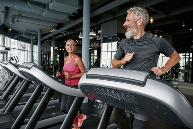 Man and woman on treadmills