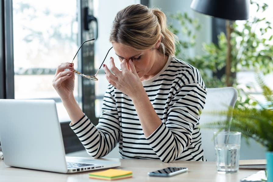 Woman working at home feeling tired